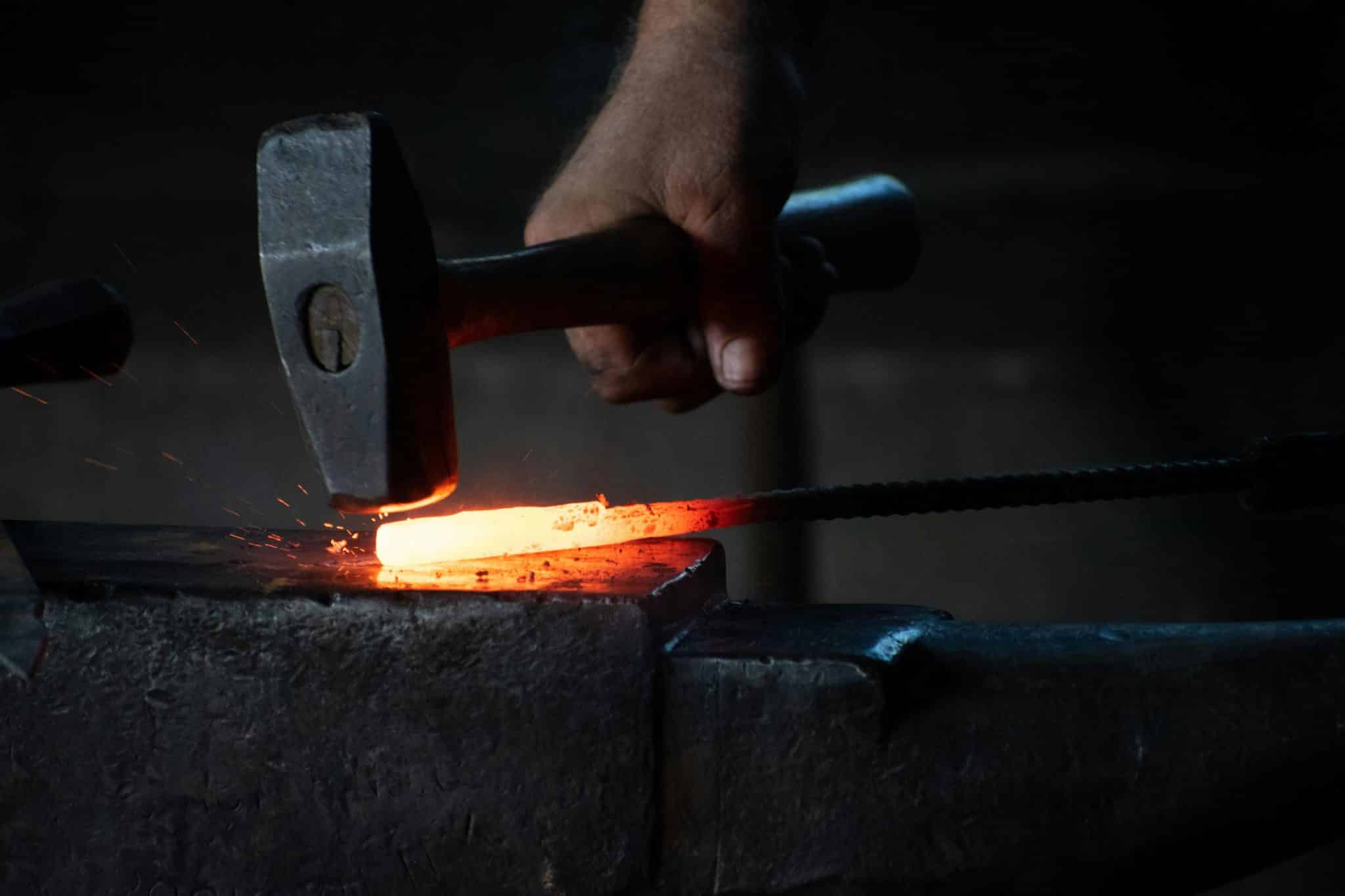 A B.B. Price blacksmith forging a forged engine part